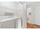 Convenient laundry room featuring a white washer and dryer with wire shelving at 522 Johnson St, Garner, NC 27529