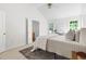 Bright primary bedroom boasts vaulted ceiling and view into ensuite bathroom at 522 Johnson St, Garner, NC 27529