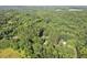 Aerial view of lush land with house, pool and driveway at 5414 Ventoria Rd, Durham, NC 27712