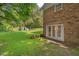 Brick home with a walkout to the level backyard and lawn at 5414 Ventoria Rd, Durham, NC 27712