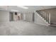 Large finished basement with carpeted floors and a staircase at 5414 Ventoria Rd, Durham, NC 27712