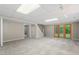 Finished basement features neutral carpet, lighting, and a walkout to the backyard at 5414 Ventoria Rd, Durham, NC 27712
