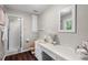 Bathroom featuring a shower, white countertop with decor, and a framed mirror at 5414 Ventoria Rd, Durham, NC 27712
