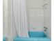 Retro bathroom with a blue tub and white tile at 5414 Ventoria Rd, Durham, NC 27712