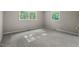 Bright bedroom with carpet and two sunny windows at 5414 Ventoria Rd, Durham, NC 27712