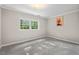 Bright bedroom featuring neutral carpet, paint, and a window at 5414 Ventoria Rd, Durham, NC 27712