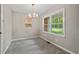 Cozy dining room featuring neutral walls, plush carpeting, and abundant natural light through large windows at 5414 Ventoria Rd, Durham, NC 27712