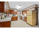Traditional kitchen with wood cabinets, white countertops, and vintage appliances, blending charm and functionality at 5414 Ventoria Rd, Durham, NC 27712