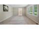 Spacious living room with neutral carpet and large windows allowing natural light to fill the space at 5414 Ventoria Rd, Durham, NC 27712