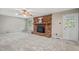 Cozy living room features a brick fireplace, large windows, and plush carpeting at 5414 Ventoria Rd, Durham, NC 27712