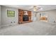 Comfortable living room with brick fireplace, ceiling fan, and access to dining area at 5414 Ventoria Rd, Durham, NC 27712