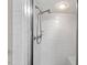 White tile shower with adjustable shower head and glass door at 5414 Ventoria Rd, Durham, NC 27712