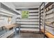 Storage area with shelves, window, and workbench, perfect for tools and hobbies at 5414 Ventoria Rd, Durham, NC 27712