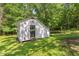 Outdoor storage shed located in the large, tree-lined backyard at 5414 Ventoria Rd, Durham, NC 27712
