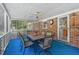 Bright sunroom with seating area, ceiling fan and views of private, landscaped backyard at 5414 Ventoria Rd, Durham, NC 27712
