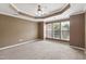 Bedroom featuring a tray ceiling, carpet flooring, and lots of natural light at 5503 Silver Moon Ln, Raleigh, NC 27606