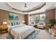 Main bedroom featuring a tray ceiling, lots of natural light, and a ceiling fan at 5503 Silver Moon Ln, Raleigh, NC 27606