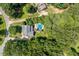 Aerial view of a home in a lush, wooded neighborhood featuring a private pool and long driveway at 5712 Turner Store Ln, Raleigh, NC 27603