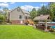 Landscaped backyard features a gazebo, pool, and screened porch for outdoor living at 5712 Turner Store Ln, Raleigh, NC 27603