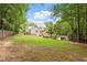 Expansive backyard with lush greenery offers a private oasis and plenty of room at 5712 Turner Store Ln, Raleigh, NC 27603