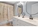 Well-lit bathroom with double vanity sinks, large mirrors, and a shower curtain at 5712 Turner Store Ln, Raleigh, NC 27603