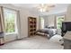 Bright bedroom with large windows, plush carpet, and modern ceiling fan for a comfortable and inviting space at 5712 Turner Store Ln, Raleigh, NC 27603