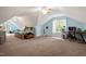 Spacious upper-level bedroom with sloped ceilings, natural light, a ceiling fan, and comfortable furnishings at 5712 Turner Store Ln, Raleigh, NC 27603