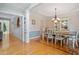 Elegant dining room features hardwood floors and a stylish chandelier at 5712 Turner Store Ln, Raleigh, NC 27603
