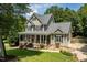 Charming two-story home featuring a welcoming front porch and beautifully landscaped front yard at 5712 Turner Store Ln, Raleigh, NC 27603