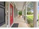 Inviting front porch with stately columns and a vibrant red door welcomes you home at 5712 Turner Store Ln, Raleigh, NC 27603