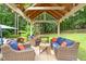 Charming gazebo with comfortable seating is perfect for outdoor relaxation and entertaining at 5712 Turner Store Ln, Raleigh, NC 27603