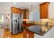Kitchen featuring stainless steel refrigerator, granite countertops and breakfast bar at 5712 Turner Store Ln, Raleigh, NC 27603