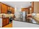 Kitchen featuring granite countertops, stainless steel appliances, and backsplash at 5712 Turner Store Ln, Raleigh, NC 27603