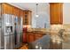 Kitchen featuring granite countertops, cherry cabinets, and stainless steel refrigerator at 5712 Turner Store Ln, Raleigh, NC 27603