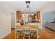 Eat-in kitchen boasts hardwood floors, table, chairs, stainless appliances, and lots of light at 5712 Turner Store Ln, Raleigh, NC 27603