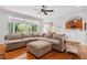 Bright living room with hardwood floors, a large sectional, and sunroom views at 5712 Turner Store Ln, Raleigh, NC 27603