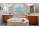 Luxurious bathroom featuring and sinks and large tub with tile surround at 5712 Turner Store Ln, Raleigh, NC 27603