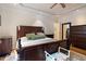 Spacious main bedroom featuring dark furniture, hardwood floors, and a tray ceiling at 5712 Turner Store Ln, Raleigh, NC 27603