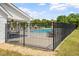 Community pool area featuring a fence, tables, and a covered seating area for residents to enjoy at 5712 Turner Store Ln, Raleigh, NC 27603