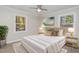 Bedroom featuring a ceiling fan, a bed with gold pillows and hardwood floors at 5917 Meadowlark Ln, Raleigh, NC 27610