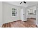 Bedroom with ceiling fan and wood floors leading to kitchen at 631 Park Ave, Rocky Mount, NC 27801