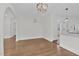 Dining area features hardwood flooring, an elegant chandelier, and transitions into the kitchen at 631 Park Ave, Rocky Mount, NC 27801