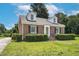 Charming brick home featuring black shutters, a manicured lawn, and a classic architectural style at 631 Park Ave, Rocky Mount, NC 27801