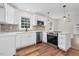 Modern kitchen features white cabinets, stainless appliances and brick backsplash at 631 Park Ave, Rocky Mount, NC 27801
