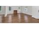 Open-concept living area with hardwood floors and fireplace, bathed in natural light from large windows at 631 Park Ave, Rocky Mount, NC 27801