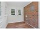 Sunroom features brick wall, windows, and wood-style flooring at 631 Park Ave, Rocky Mount, NC 27801
