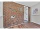 Sunroom features brick wall, windows, and wood-style flooring at 631 Park Ave, Rocky Mount, NC 27801