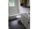 Clean bathroom with tiled walls, a white vanity, and a tub/shower combination at 704 N King Charles Rd, Raleigh, NC 27610