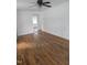 Spacious room featuring hardwood floors, fresh paint, and ample natural light streaming through the windows at 704 N King Charles Rd, Raleigh, NC 27610
