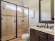 Tiled bathroom featuring a glass enclosed shower and granite countertop vanity at 7906 Longleaf Branch Ct, Raleigh, NC 27612